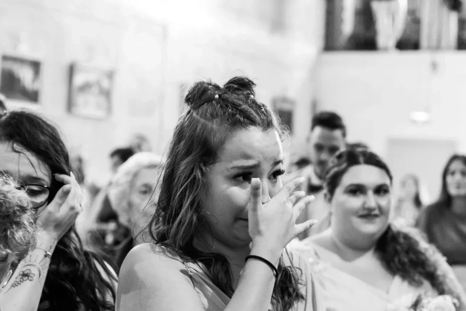 Wedding guest wiping tears during the ceremony in Châteauneuf-le-Rouge.