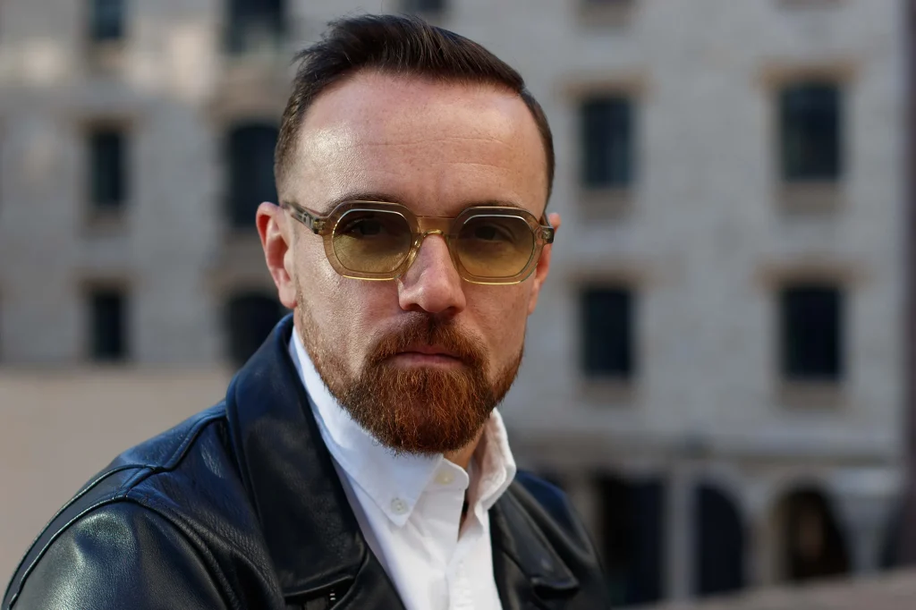 Portrait of a man with glasses and a beard in an urban setting in Marseille