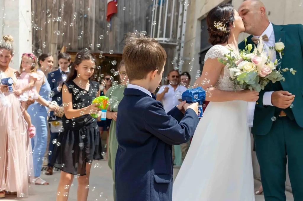 Newlyweds leaving Aubagne town hall under bubbles after their wedding ceremony