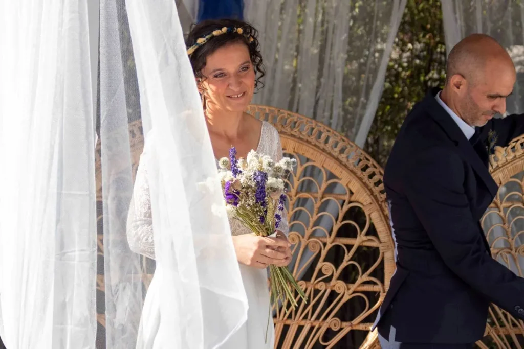 Bride smiling during an outdoor wedding ceremony in Cuges-les-Pins