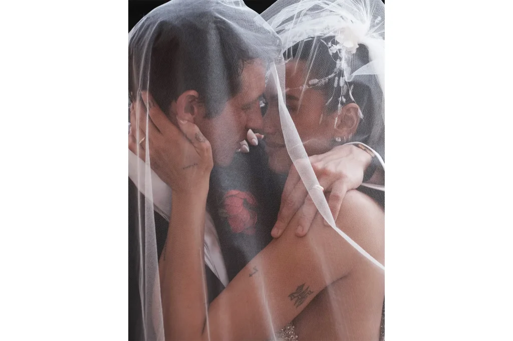 Dua Lipa and Callum Turner sharing an emotional moment under the veil during their wedding in Palermo, Sicily