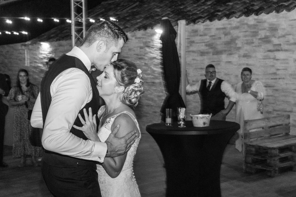 Tender, relaxed moment between newlyweds at their wedding reception in Trets, black and white